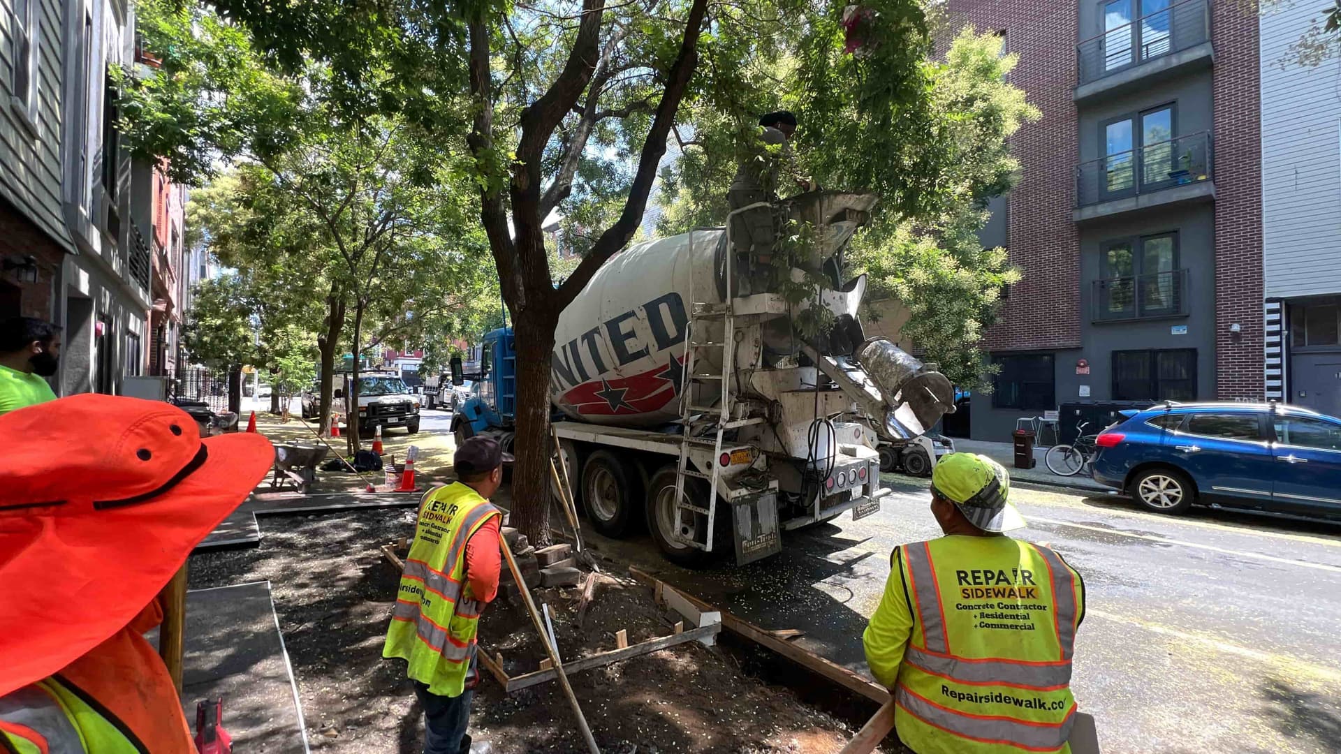 Concrete truck and crew performing sidewalk work in NYC