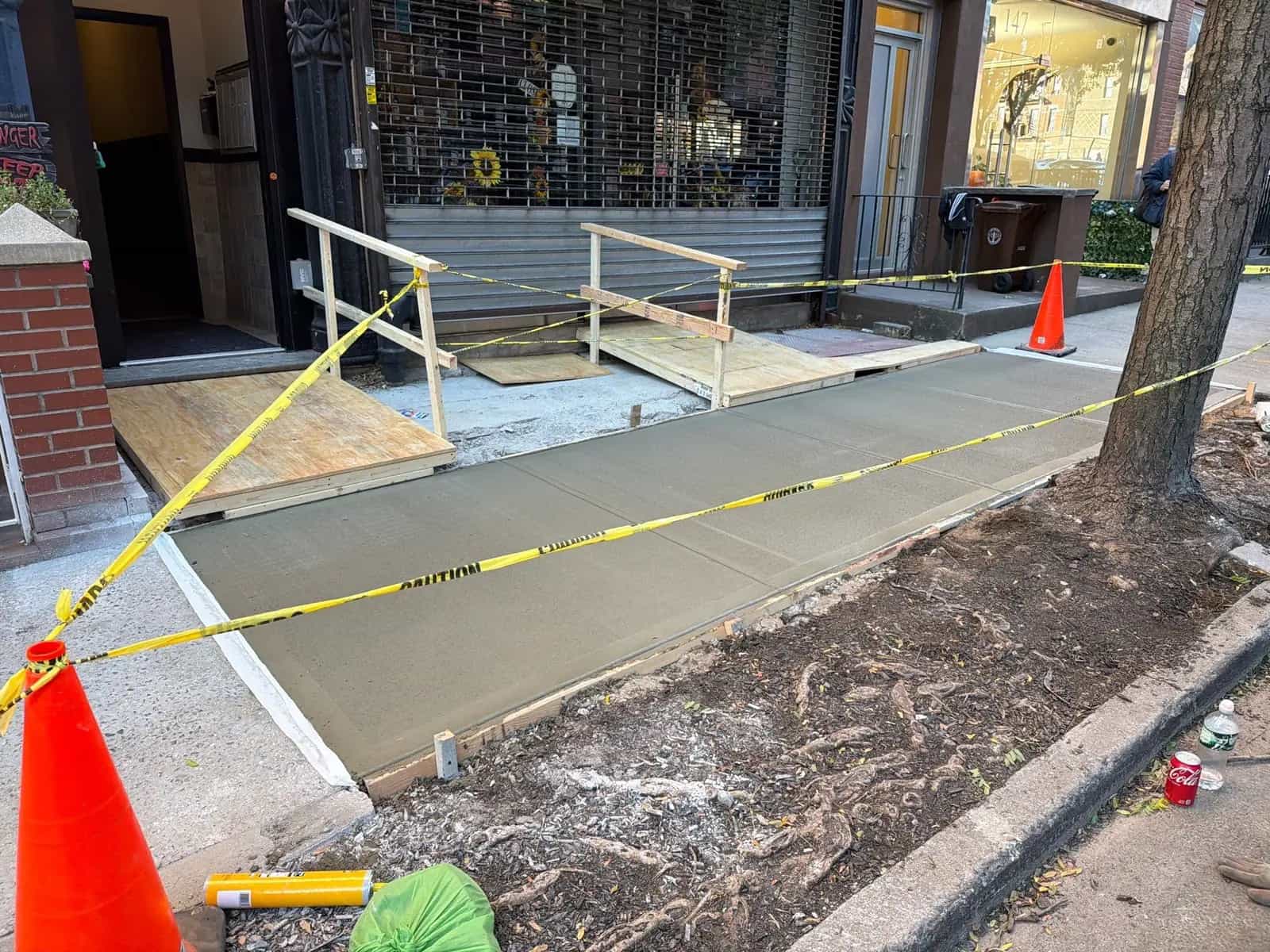 NYC sidewalk concrete contractor finishing a storefront sidewalk